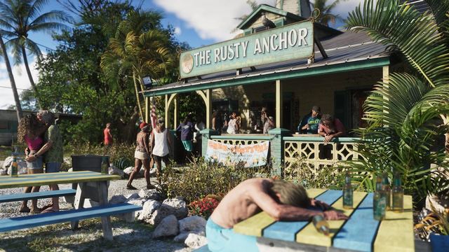 The exterior of a beach bar in the Leonida Keys with many people: a man sits at a picnic table passed out surrounded by empty bottles, a couple is kissing, people are walking into the entrance, and others are hanging out on the front porch.